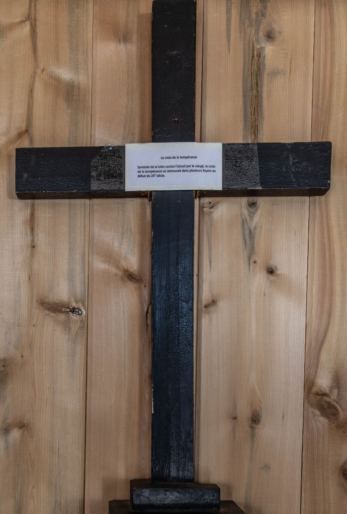 A wooden cross painted black