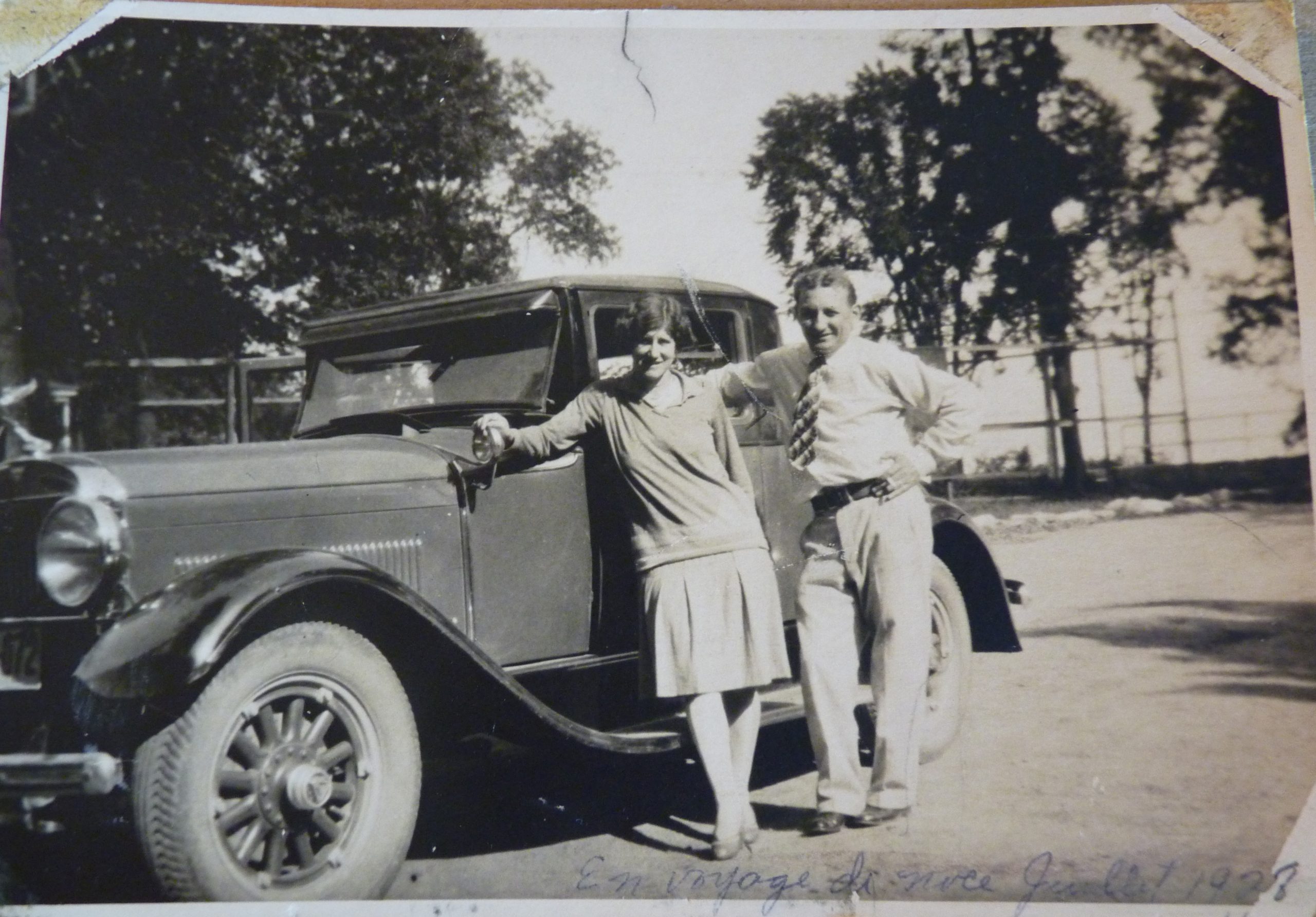 Young couple in front of a 1928 car