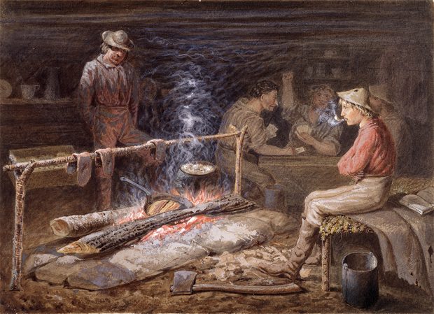 A painting of gold miners in a cedar cabin. Two individuals in the foreground are cooking over an open fire. Three men in the back are playing cards at a table.