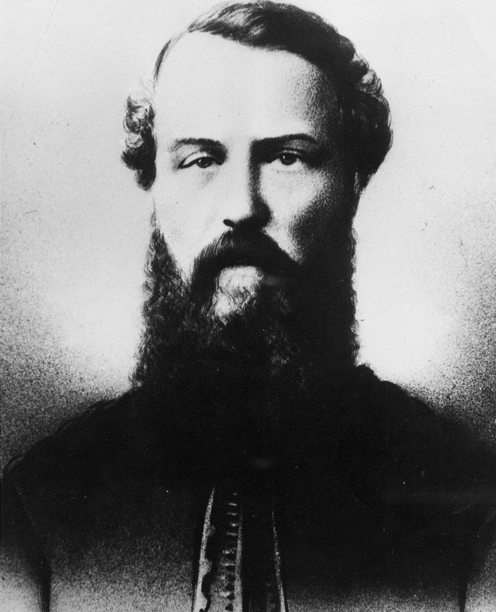 A black and white bust portrait of a bearded Colonel Richard Clement Moody wearing a military jacket.