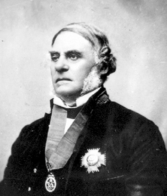 A black and white studio portrait photograph of Governor James Douglas wearing a medal around his neck and an ornate badge on the front of his jacket.