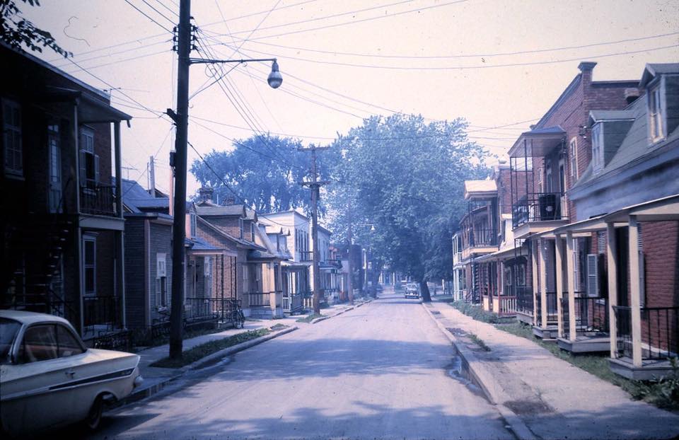 A quiet street with two parked cars