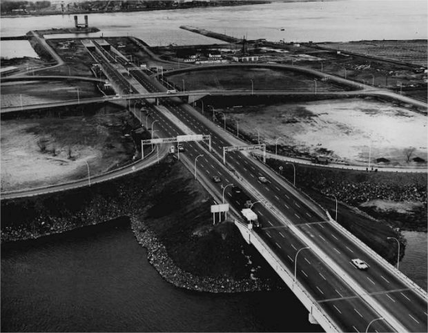 Cars on a highway with a river in the background