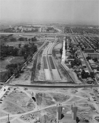 A highway with a hospital and residential buildings in the background