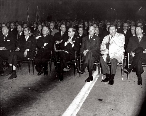 Men sitting on the side of a highway