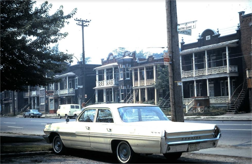 Street scene with a car parked in the foreground