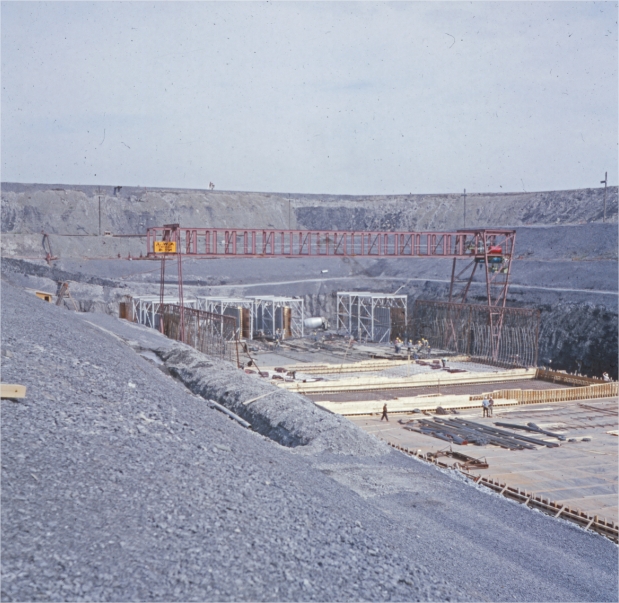 A structure under construction in a trench and a bridge crane