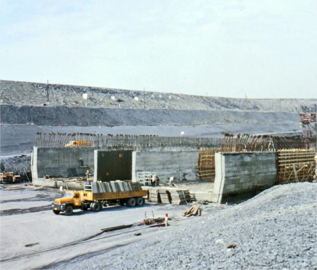 A structure under construction with a truck carrying building materials