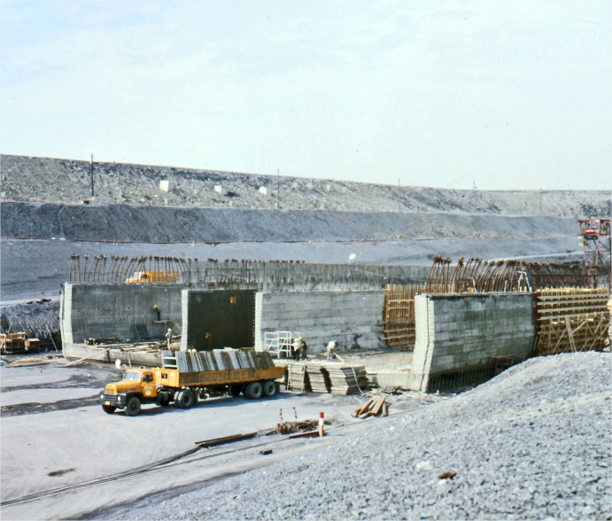 A structure under construction with a truck carrying building materials