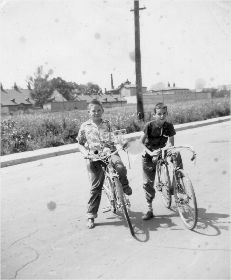 Two children riding their bikes on a Boucherville street