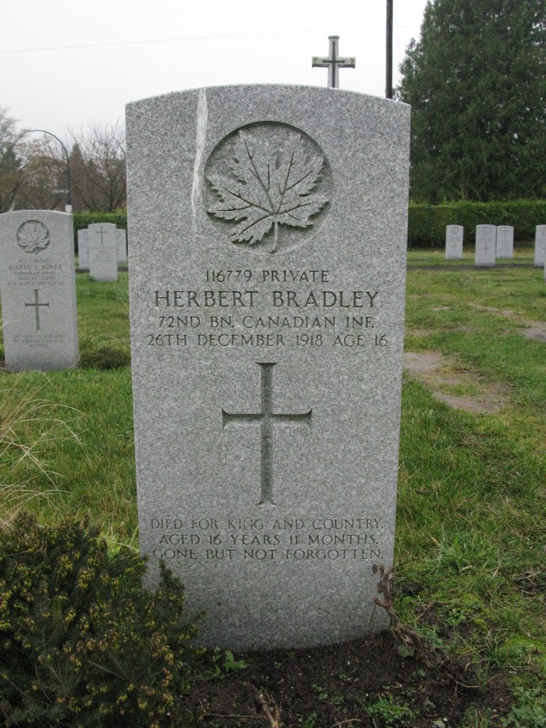 A stone headstone in a cemetery field