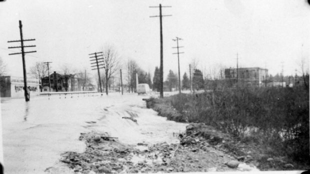 A car driving on a flooded road