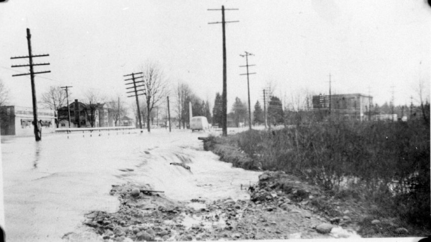 A car driving on a flooded road