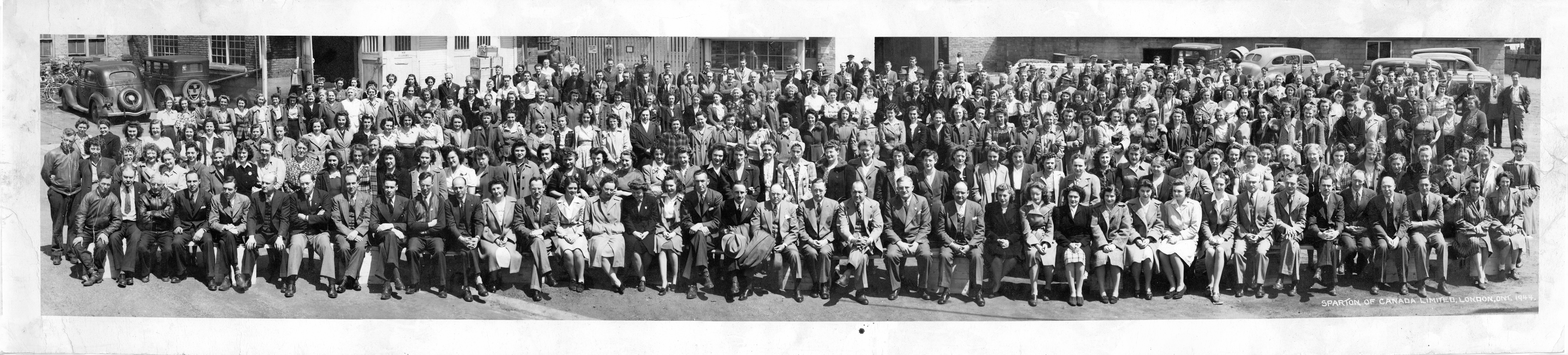 Black and white panoramic group photo, mostly women. Text reads, "Sparton of Canada, London, Ont., 1944"