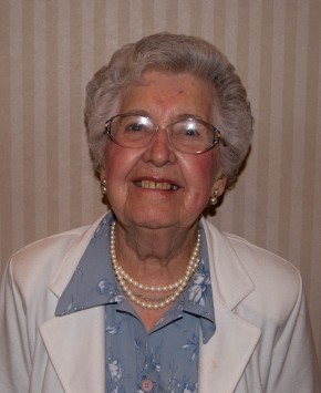Portrait of a mature woman with glasses smiling.