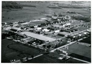 black and white, birds-eye view of an Air Force base; farmer's fields in the distance.