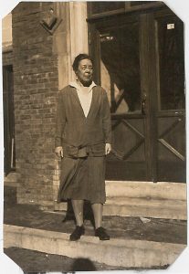 Dr. Laird in calf-length dress standing outside