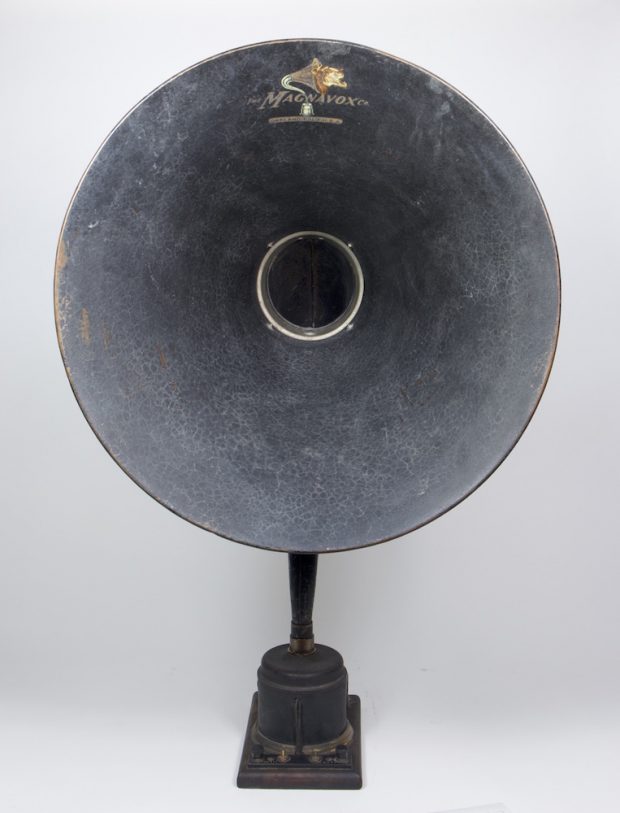 The large speaker horn, as seen from the front, is attached to a small but heavy, square metal base.