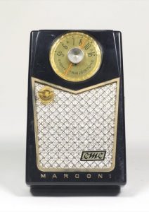 This small and precious looking radio imitates a Bakelite brown casing, with gold accents and an imitation textile front.