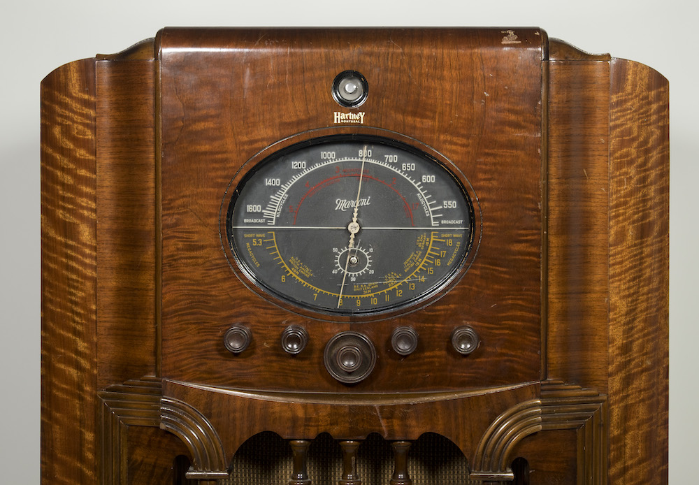 Detail of the radio showing the console with five circular dials below.