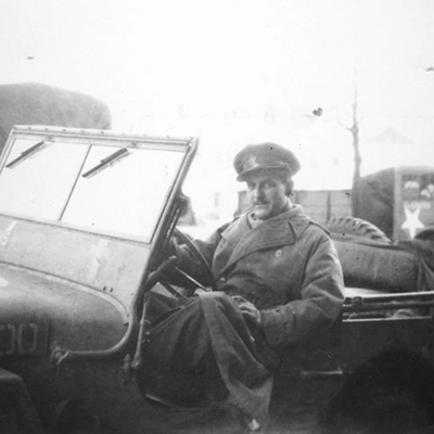 Black and white photograph of CBC radio broadcaster Marcel Ouimet in a military jeep. Photograph taken around 1944.