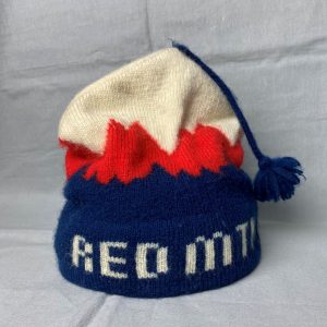 Blue, red, and white toque with a blue tassel.
