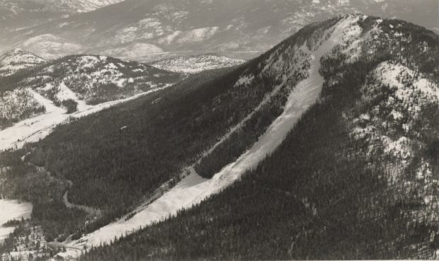 Black and white aerial photograph of the main run down the face of Red Mountain looking southeast.