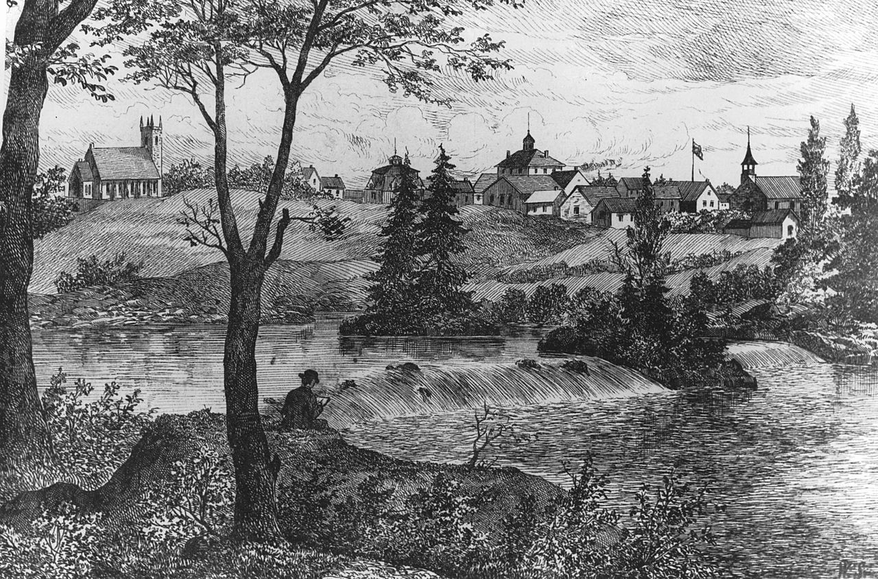 Gravure représentant un homme lisant sur la rive à la hauteur des rapides de la rivière Saint-François. Sur l’autre rive, on peut voir plusieurs maisons et les deux églises de Drummondville.