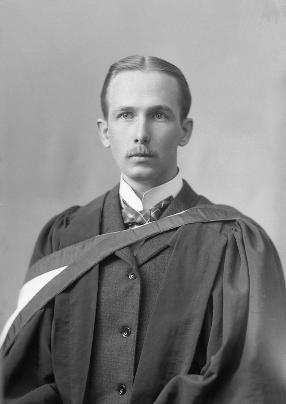 Black and white photograph of a man wearing a robe.