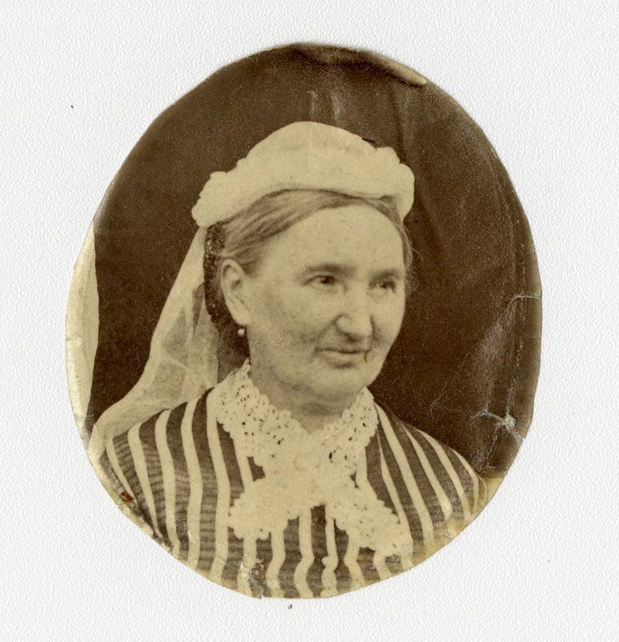 Black and white photograph of a woman wearing a hat and clothing with a lace collar.
