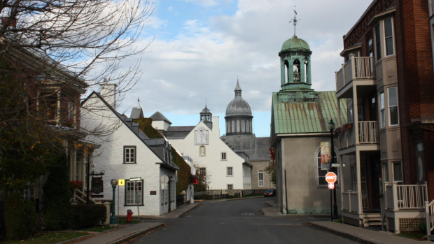 Old buildings frame the narrow street. Two steeples are visible, almost opposite each other.