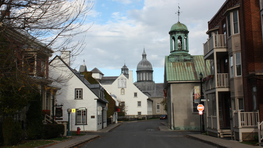 Old buildings frame the narrow street. Two steeples are visible, almost opposite each other.