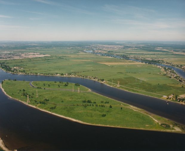 Colour aerial photograph of the Mitan archipelago surrounded by the Des Prairies River in summer. The islands are a lush green.