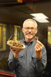 Dan Rubin holding a bowl (left hand) and small onion (right hand).