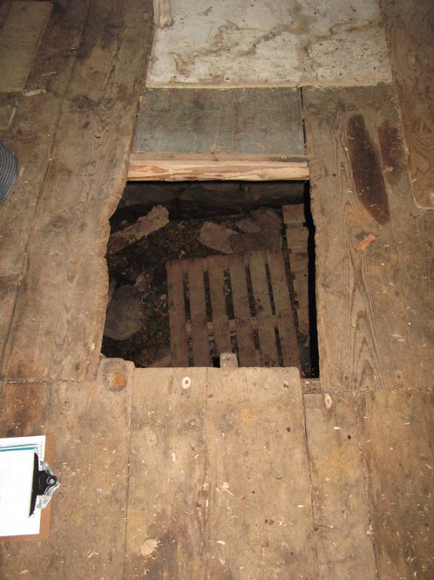 Looking down the hatch entrance of a root cellar.