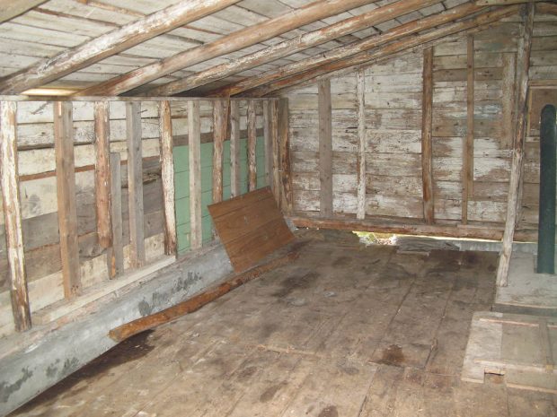 Interior of a root cellar top shed constructed with wood.