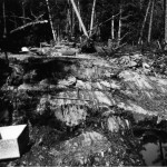 Prospectors Search Occurrence of Precious Ore Deposits on a Rock Outcrop