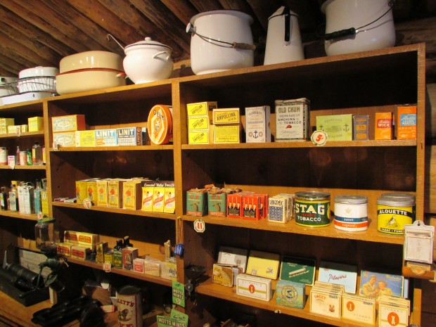 Colour photograph of three shelves filled with products from the 1920s.