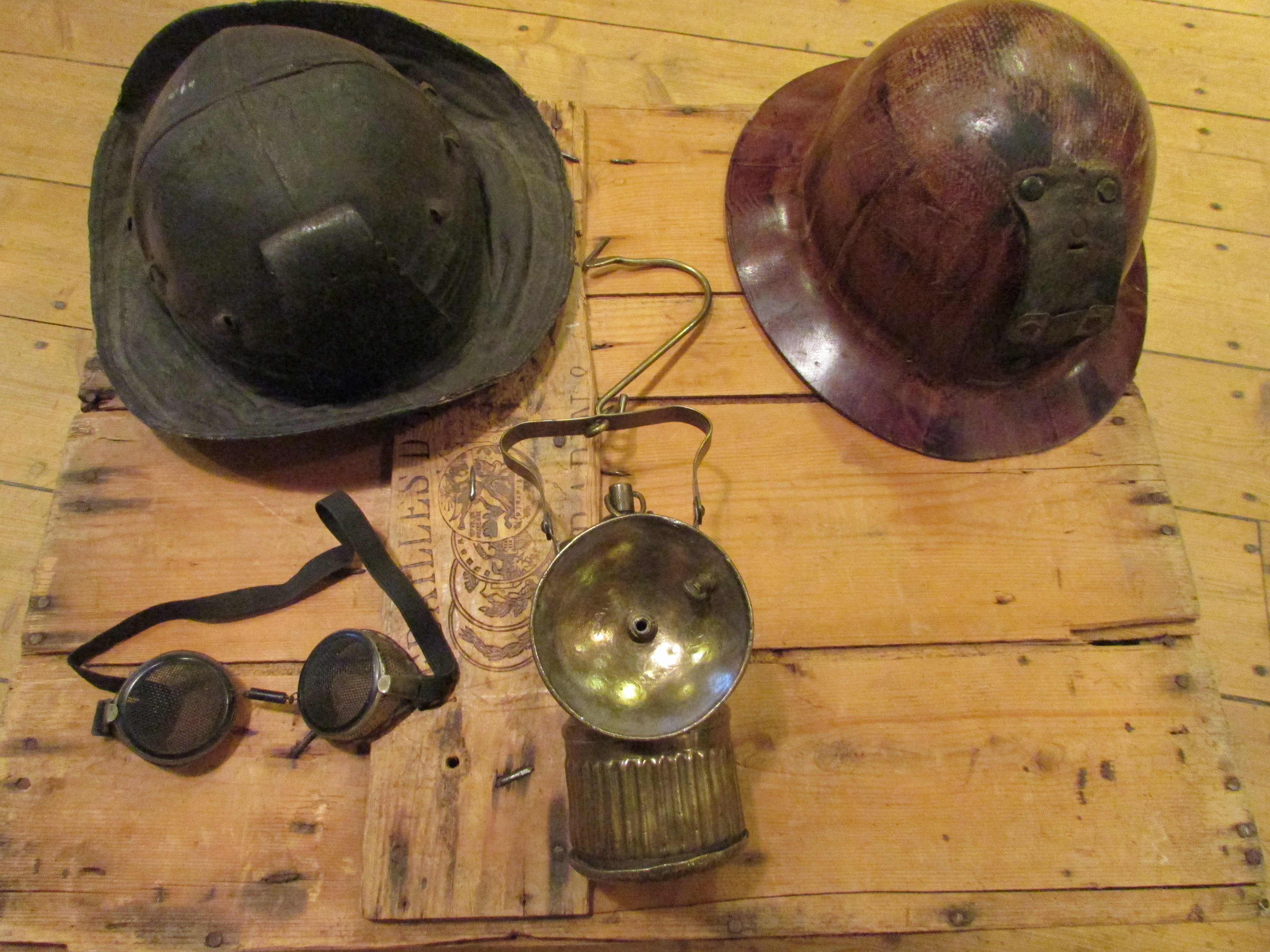 Colour photograph of four artifacts on a wooden box.