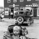 Two children in a stroller in front of the Shannon building in the 1940s