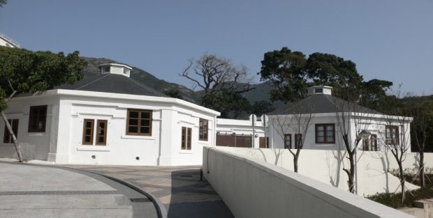 Colour photo of a white building with two hexagonal wings.