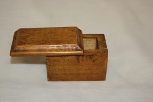 This rebellion box is made of maple and was intended for Mrs. Jane Anderson. Like the other rebellion boxes the lid slides out and is adorned with very faded scripture.
