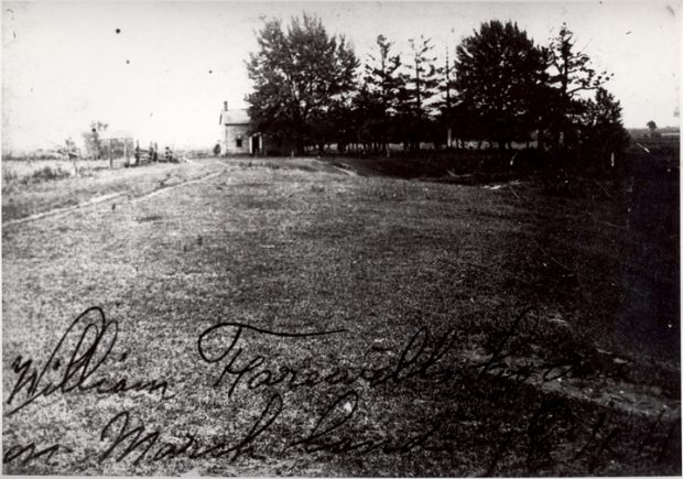 Black and white photograph of a house with large trees surrounding it. Written on the photograph is 'William Farewell house on Marsh land 1844'.