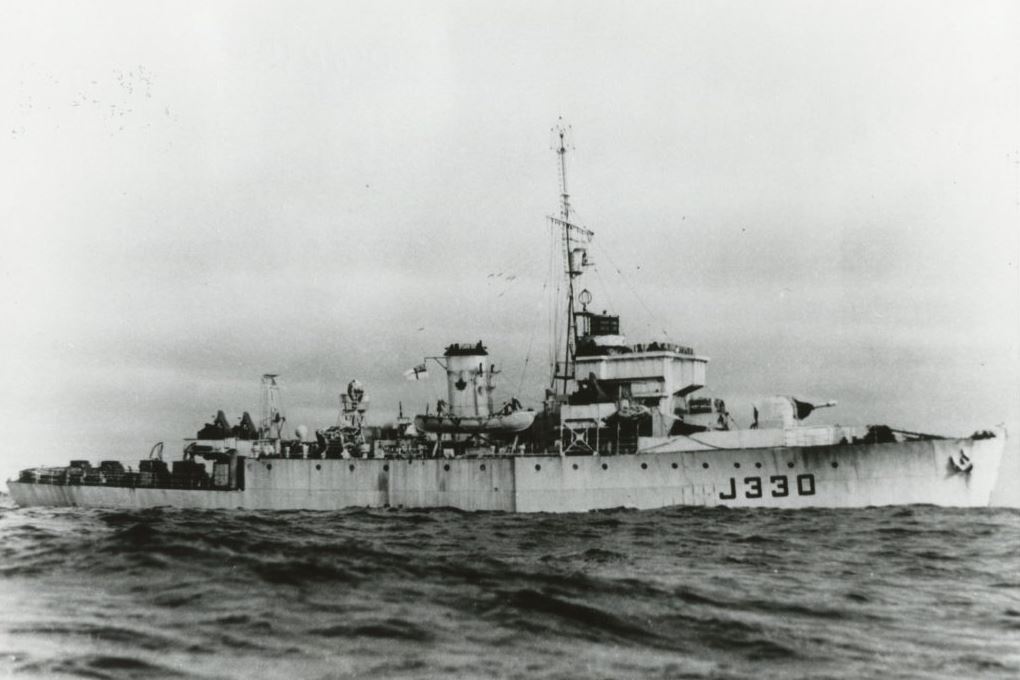 A black and white photograph of a ship with J330 written on the side.
