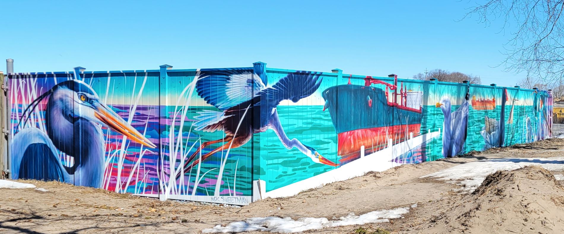 Colour photograph of a mural featuring birds and a large ship.