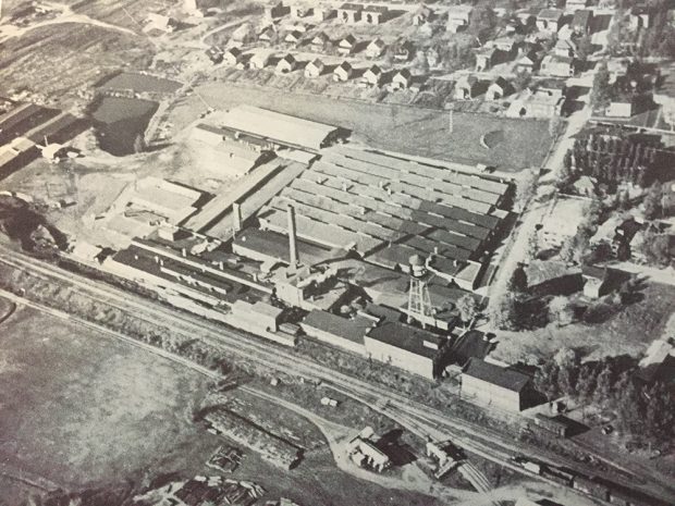 Aerial photo of the Bruck Mills factory with the adjacent railway and workers' houses.