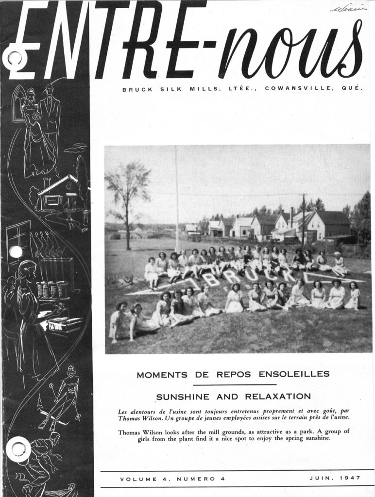 Cover page of the magazine Entre-Nous with two rows of workers sitting on the grass around a flower bed that reads 