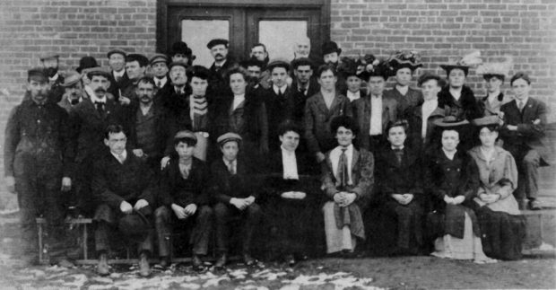 Black and white photo showing 38 employees of Bruck Silk Mills wearing typical 1920s clothing
