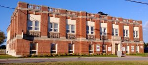 Coloured photograph of a factory building.