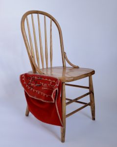 Chair with embroidered pouch